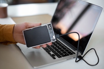 Image of a laptop connected to an external hard drive