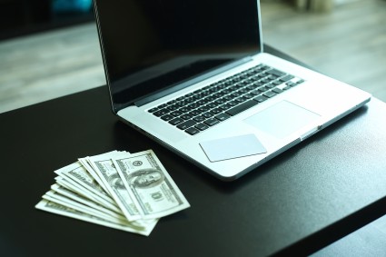 Laptop and dollar bills