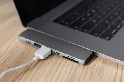 Close-up image of phone USB cable connected to laptop