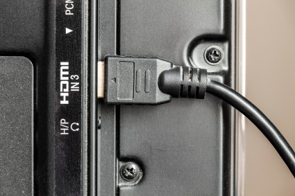 HDMI cable connected at the back of a monitor